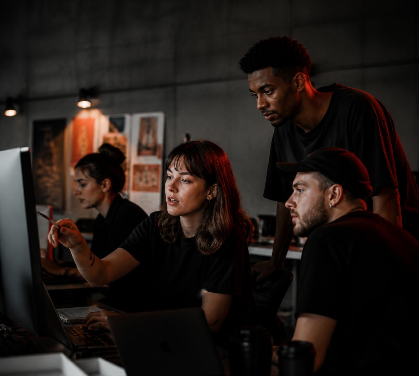 The Omado Media team reviewing creative work in a studio